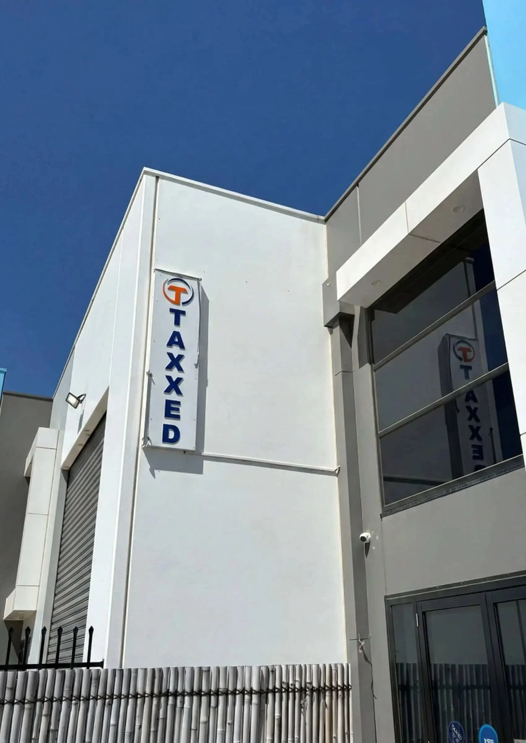Vertical building business signage installed on commercial office exterior